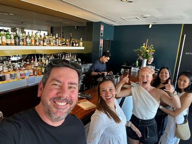 A group selfie at the bar during a private Classified mission