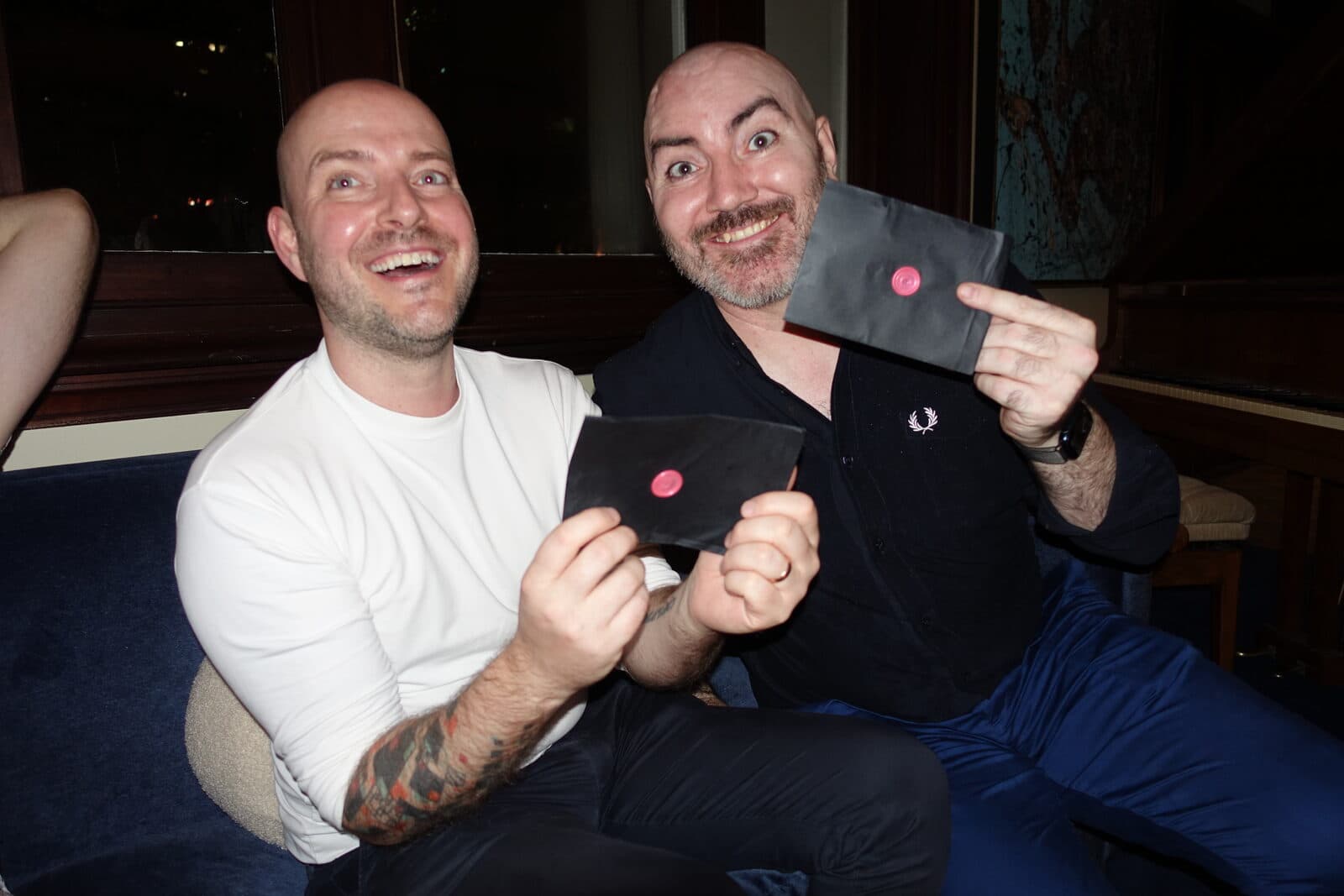 Two agents grinning while holding their clue envelopes