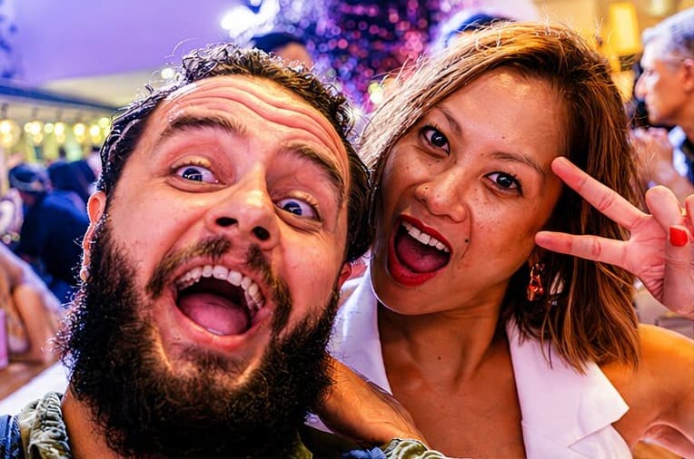 Two agents pulling excited faces for a selfie